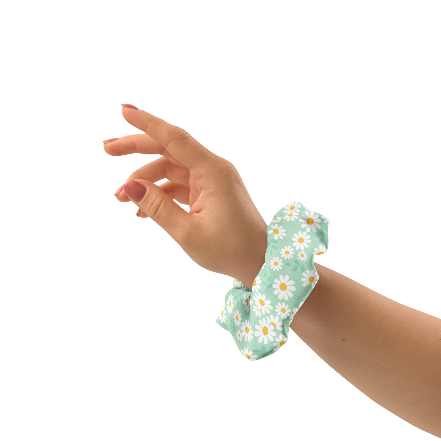 Hand wearing a green floral scrunchie on a white background