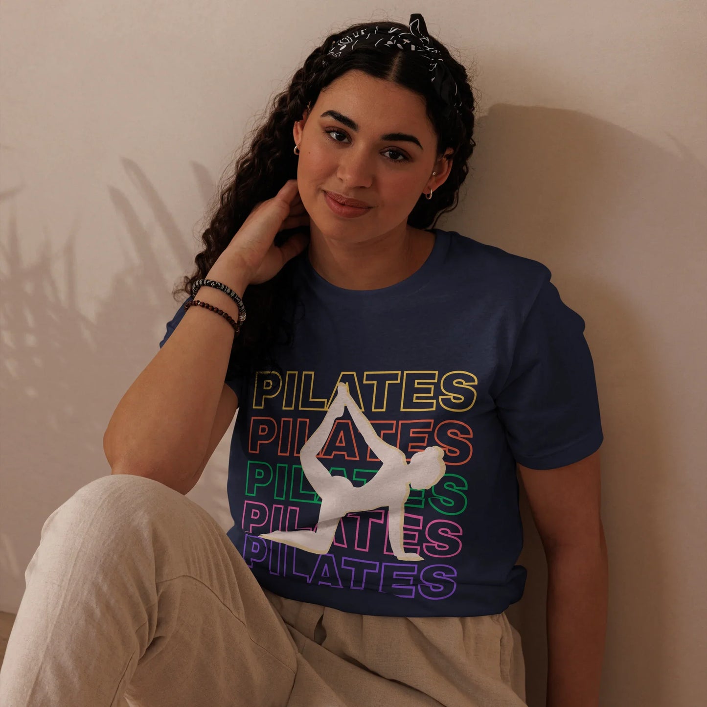 Woman wearing colorful Pilates t-shirt with bold fitness design – perfect for active lifestyle, gym, and wellness lovers
