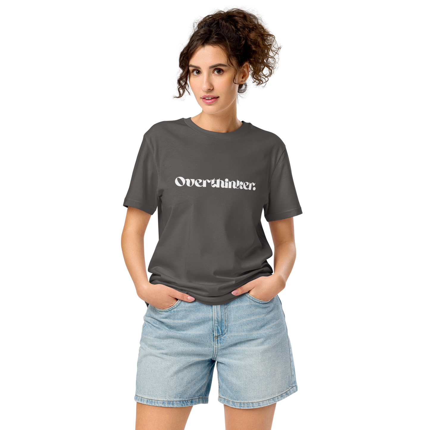 Woman wearing a gray t-shirt with 'Overthinker' text and denim shorts on a white background