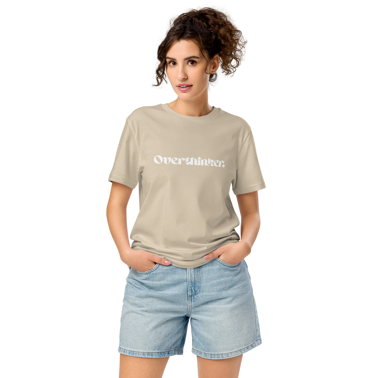 Woman wearing a beige t-shirt with text and light blue shorts on a white background