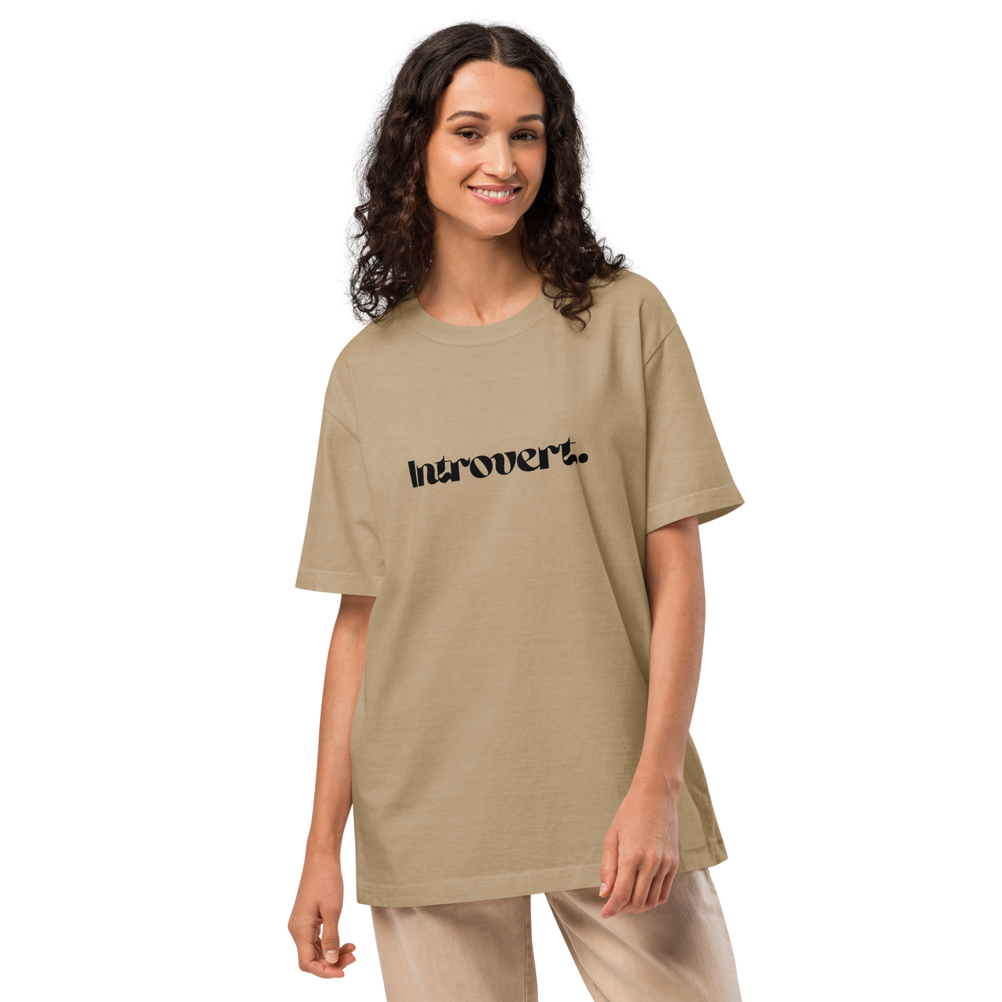 Woman wearing a beige t-shirt with 'Introvert' text on a white background