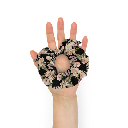 Hand holding a floral-patterned hot water bottle cover against a white background