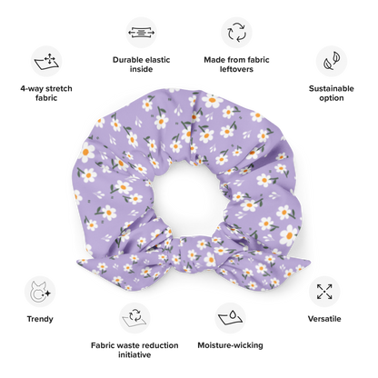 Purple floral scrunchie with sustainability features listed on a white background