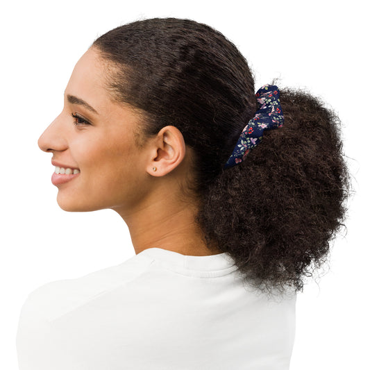 Woman with a floral scrunchie in her hair on a white background