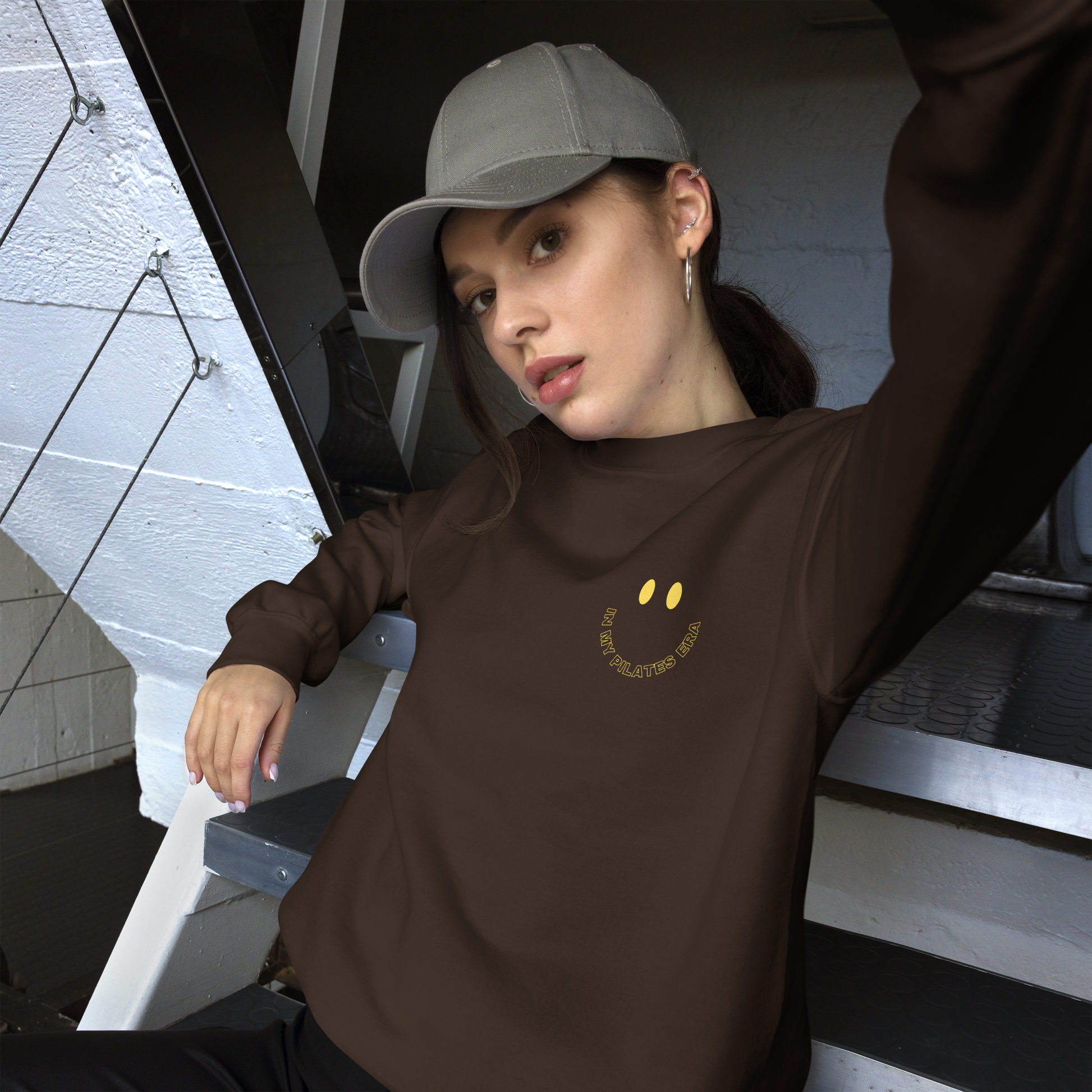 Model wearing front and back print Pilates sweatshirt in cozy athleisure look.