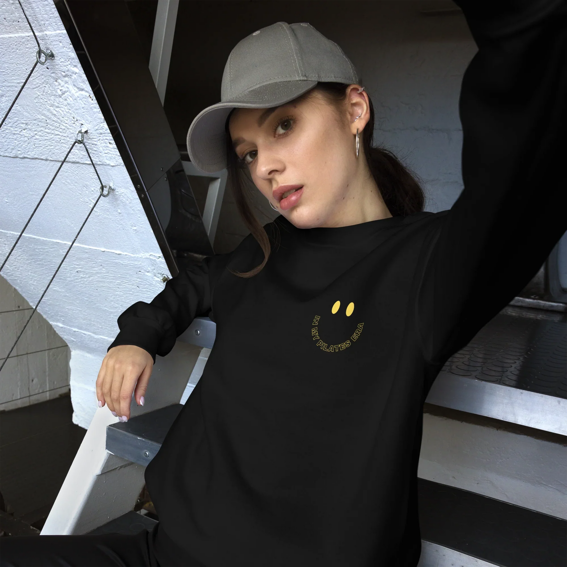Model wearing front and back print Pilates sweatshirt in cozy athleisure look.