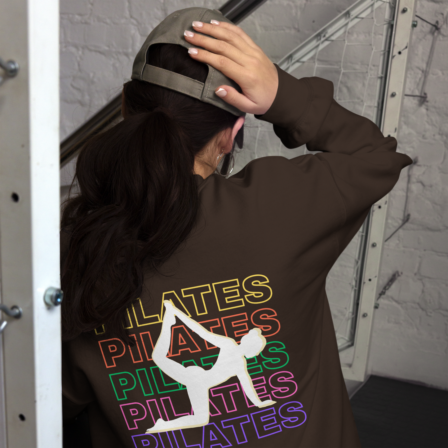 Model wearing front and back print Pilates sweatshirt in cozy athleisure look.
