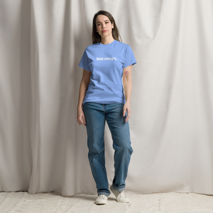 Person wearing a blue t-shirt with text and jeans against a plain background