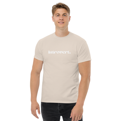 Man wearing a beige t-shirt with text on a white background