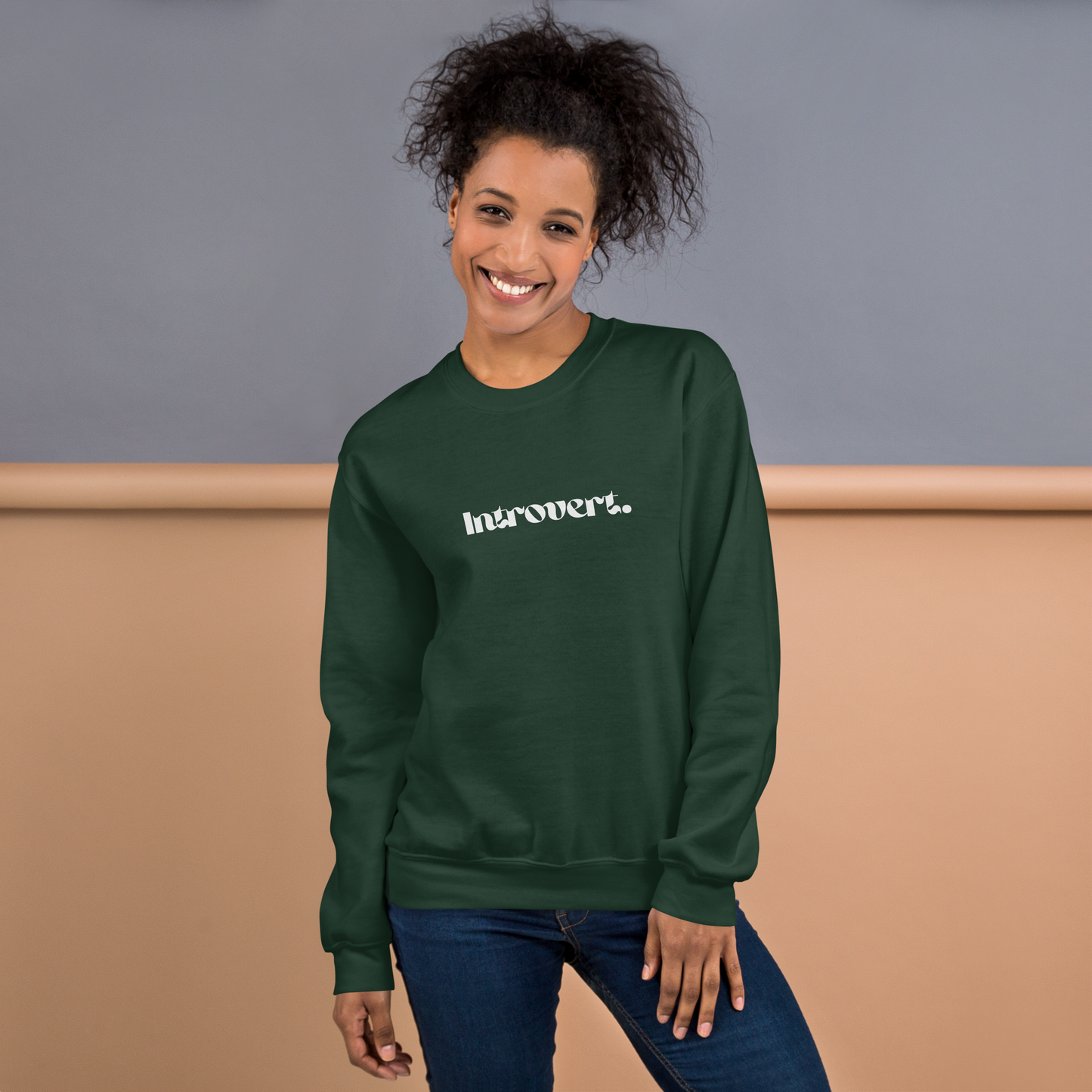 Person wearing a green sweatshirt with 'Introvert' text against a neutral background