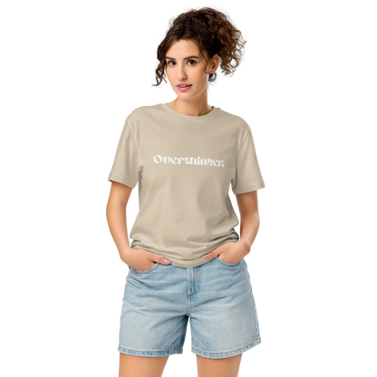Woman wearing a beige t-shirt with text and light blue shorts on a white background