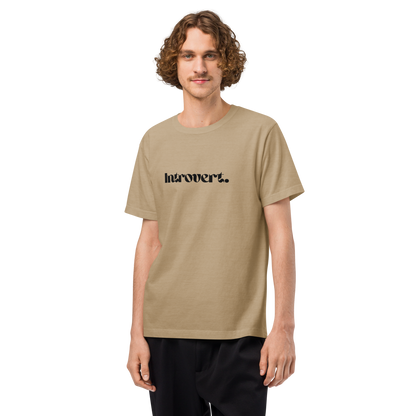 Man wearing a beige t-shirt with 'Introvert' text on a white background