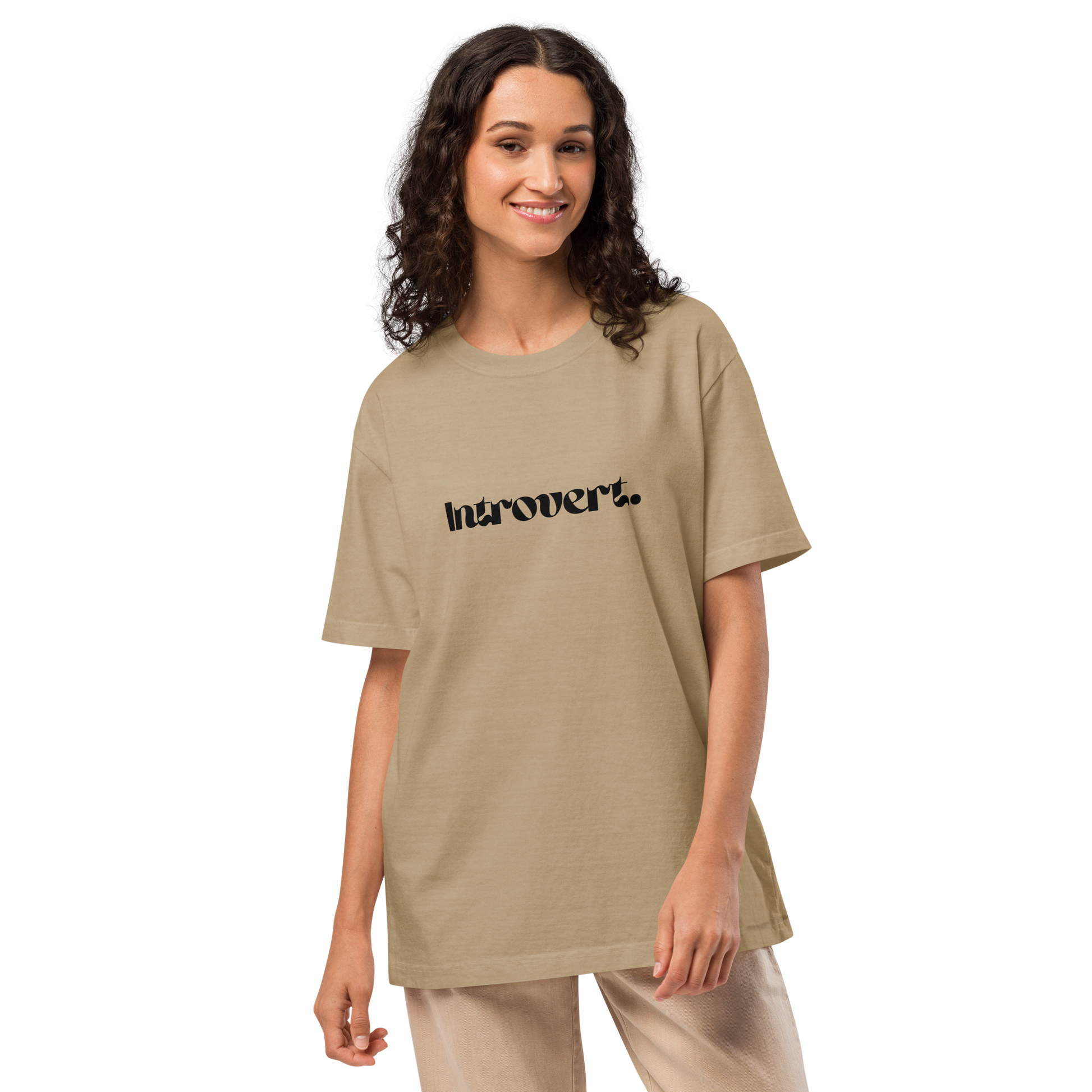 Woman wearing a beige t-shirt with 'Introvert' text on a white background