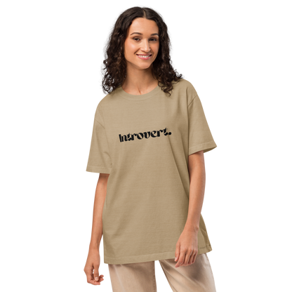 Woman wearing a beige t-shirt with 'Introvert' text on a white background