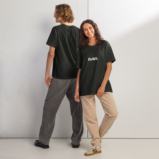 Two people wearing black t-shirts with 'Bold' text against a white wall.