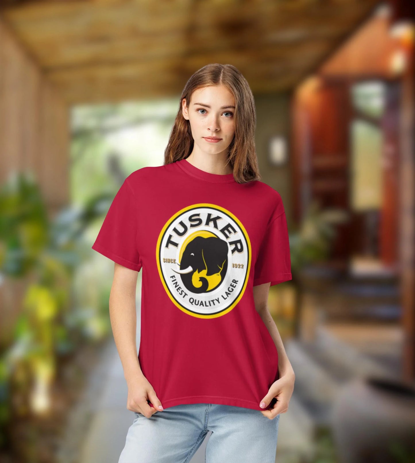 Person wearing a red Tusker beer t-shirt in an indoor setting